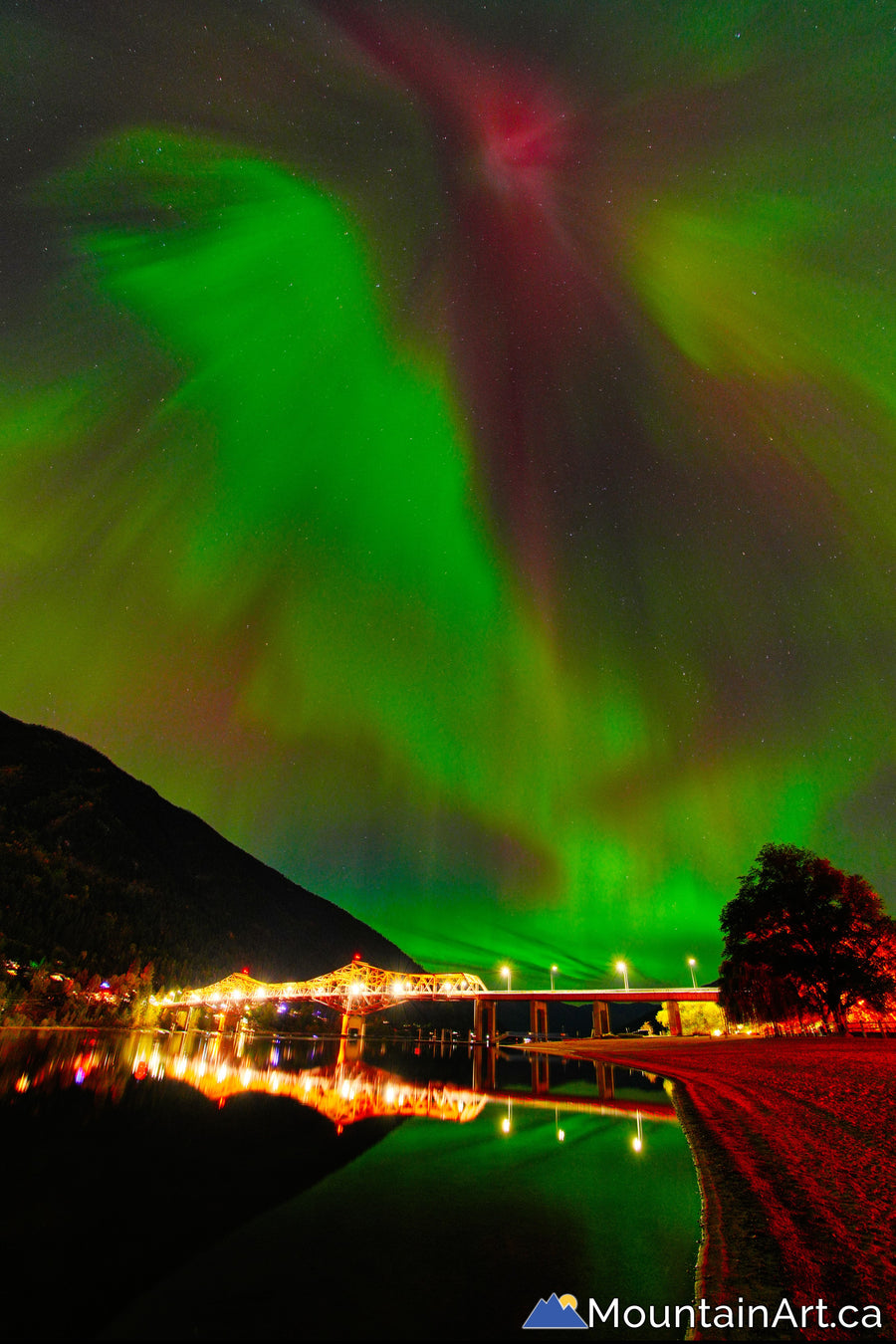 northern lights above big orange bridge lakeside park nelson bc